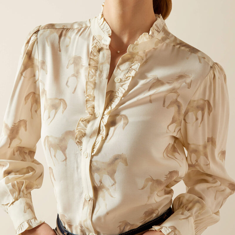 Beige blouse with horse pattern on a neutral background