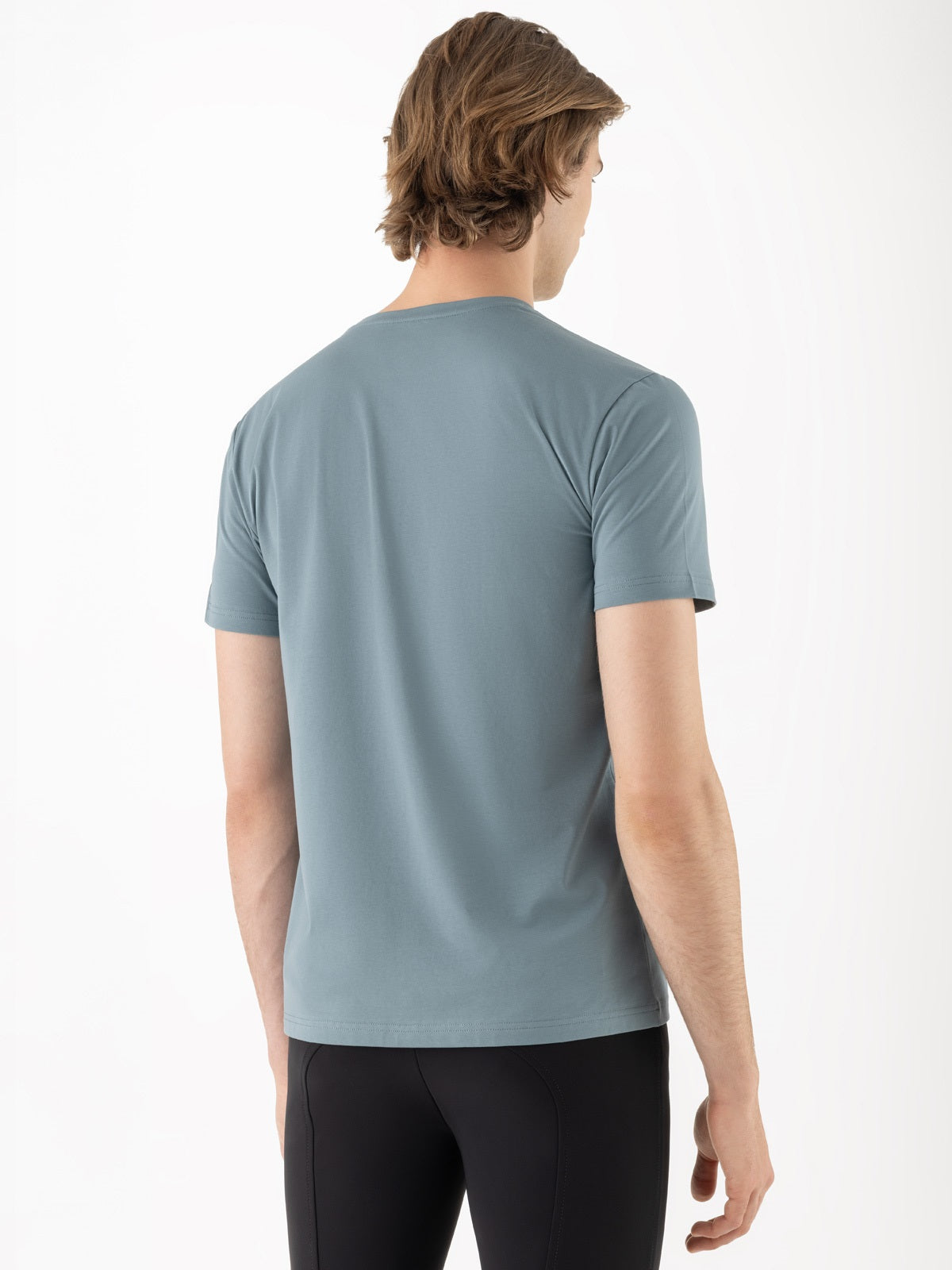 Person wearing a light blue t-shirt on a white background