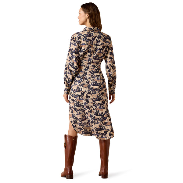 A woman shown from the back wearing a long-sleeve midi dress with an abstract dark navy and beige print, paired with brown knee-high boots, against a plain white background.