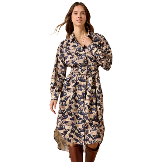 A woman modeling a long-sleeve collared shirt dress with a beige and navy blue abstract pattern, featuring a matching tie belt at the waist, set against a plain white background.