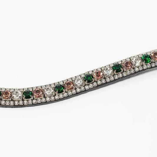 A close-up of a horse bit or bridle strap featuring a row of round gemstones in green, rose gold, and clear settings on a silver-toned metal base, set against a plain white background.