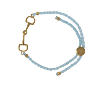 Bracelet with gold horse bit and blue cord on a white background
