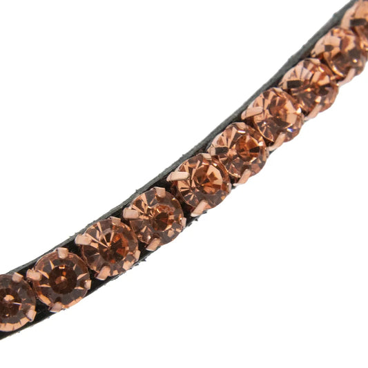 A close-up of a browband embellished with a diagonal row of faceted rose-gold-toned rhinestones on a plain white background.