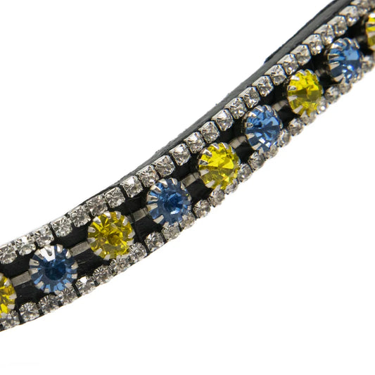 A close-up of a browband with embellished rows of clear rhinestones and alternating round yellow and blue gemstones on a white background.