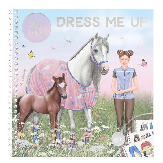 Dress-up book cover with horses and a girl in a field, featuring 'Miss Melody' brand.