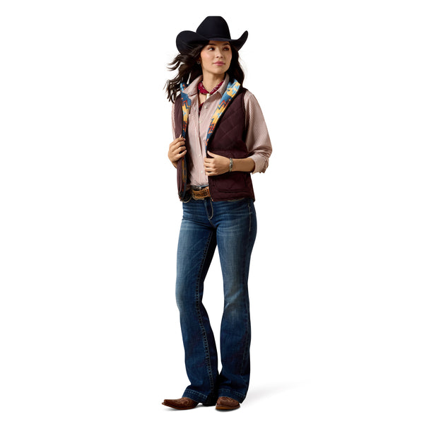 Person wearing a cowboy hat, vest, and jeans on a white background