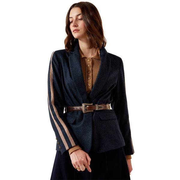 Woman wearing a dark blue blazer with sheer sleeves on a white background