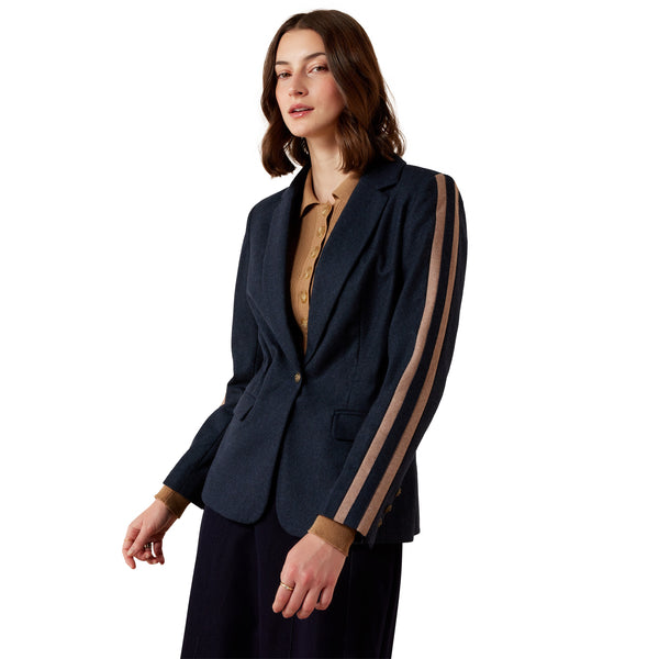 Woman wearing a navy blazer with sheer side panels on a white background