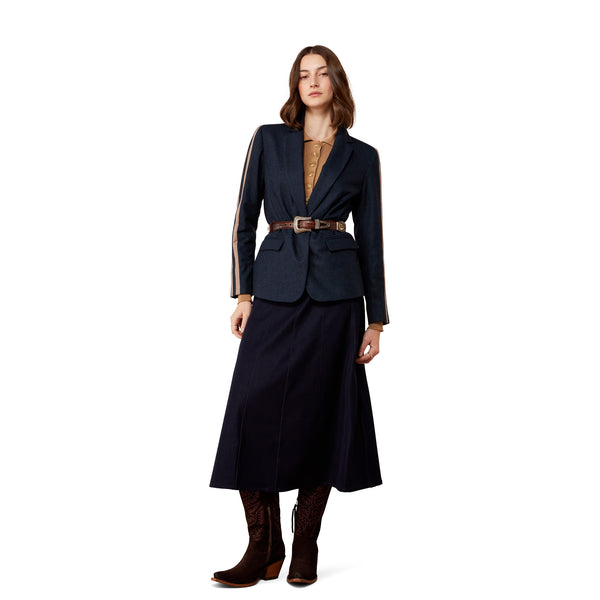 Woman wearing a navy blue suit with a belt on a white background