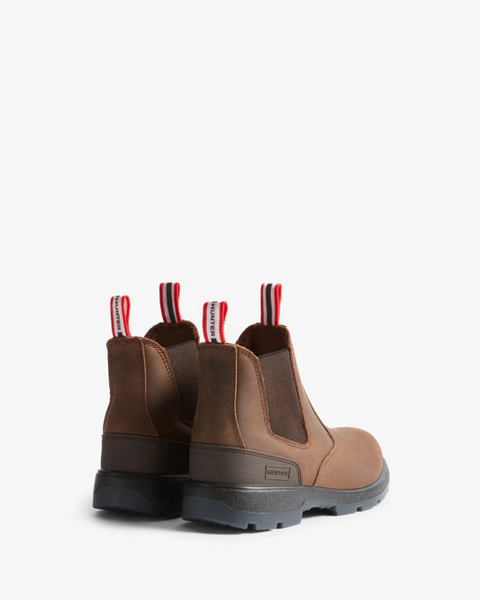 Pair of brown boots with striped laces on a white background