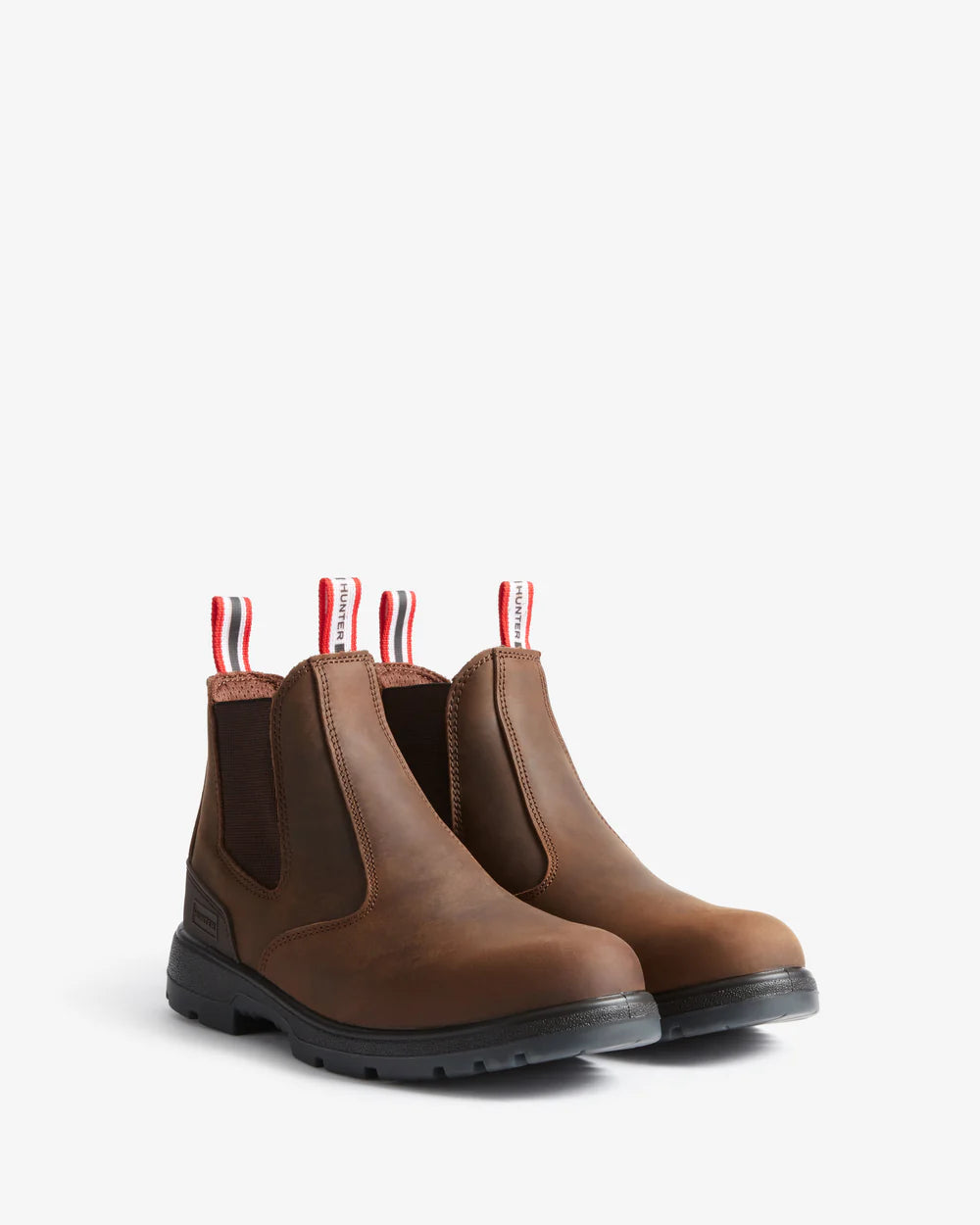 Pair of brown leather boots with striped tags on a white background