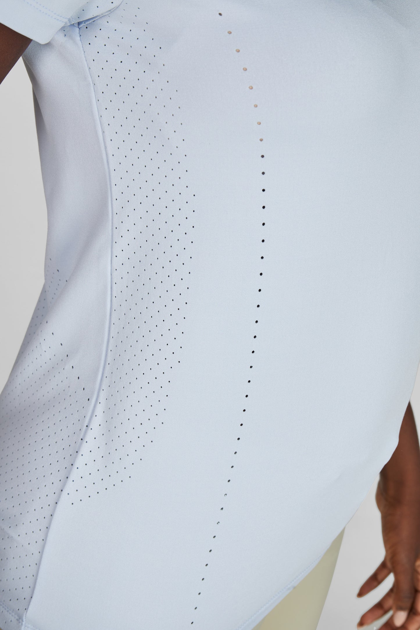 Close up of a blue t shirt with perforations