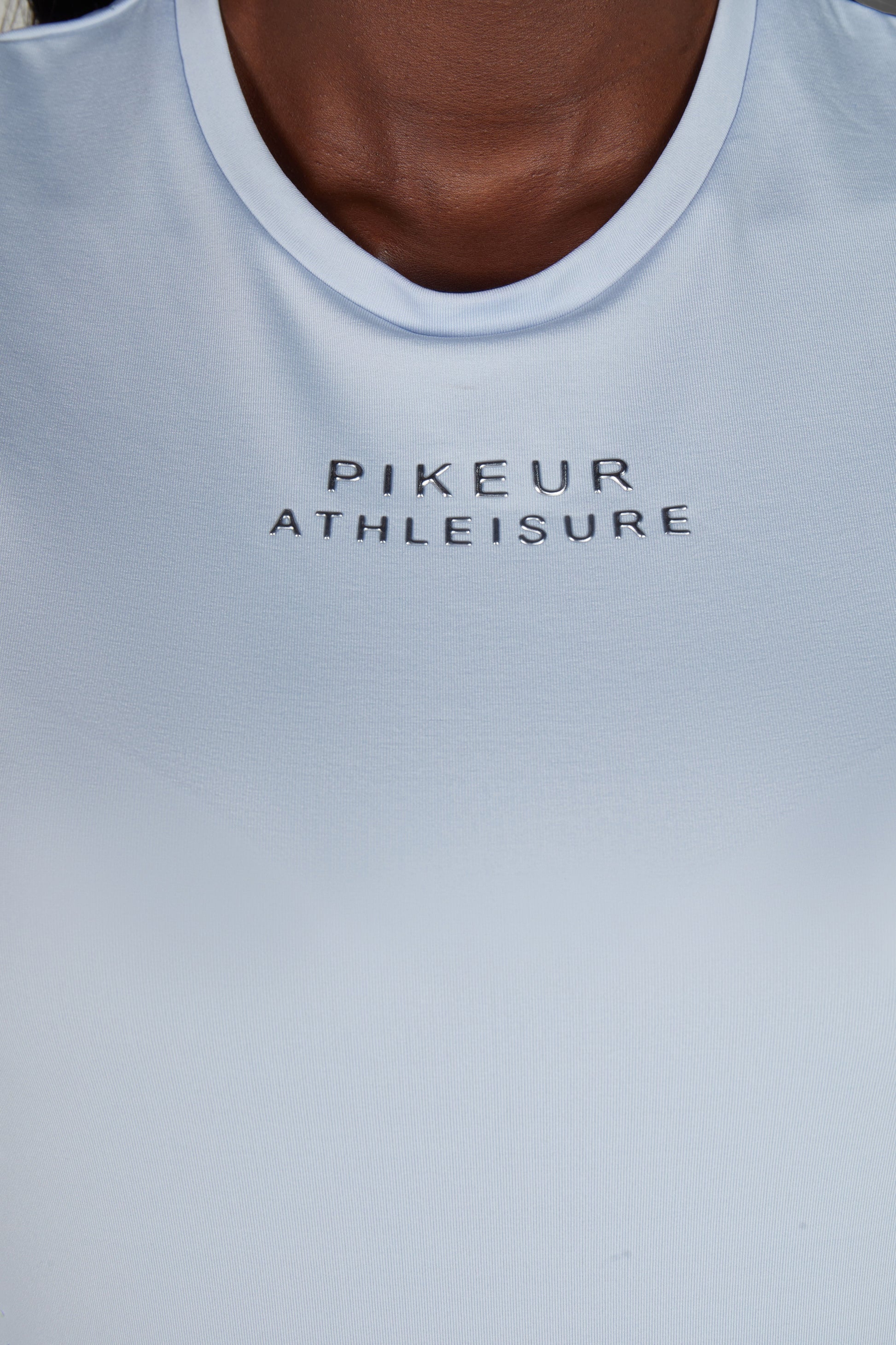 Close up of a blue t shirt reading Pikeur Athleisure 