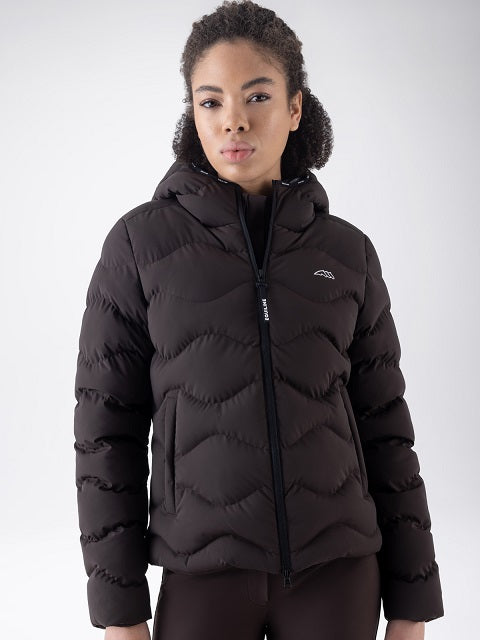 A woman wearing a dark brown hooded puffer jacket with a zigzag quilted pattern and a small white logo on the left chest, photographed against a light gray studio background.
