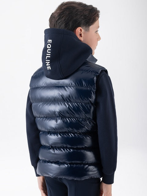 A child wearing a shiny navy puffer vest over a navy hoodie, shown from the back. The hoodie has the brand name 'EQUILINE' printed vertically in white on the back of the hood.