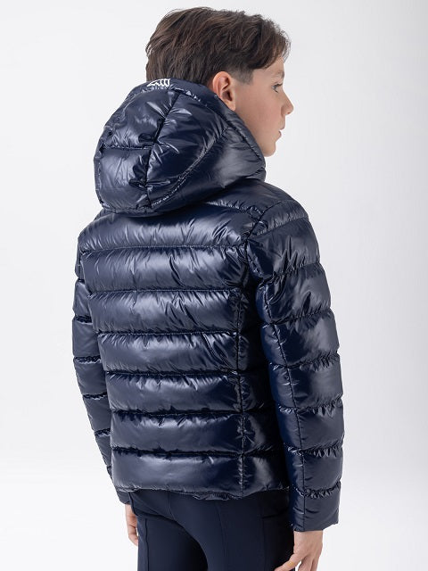 A child wearing a shiny navy blue hooded puffer jacket, shown from the back and side against a light gray studio background.
