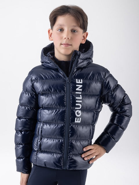 A boy wearing a shiny navy blue hooded puffer jacket with 'EQUILINE' printed vertically in white on the front, photographed against a light gray studio background.