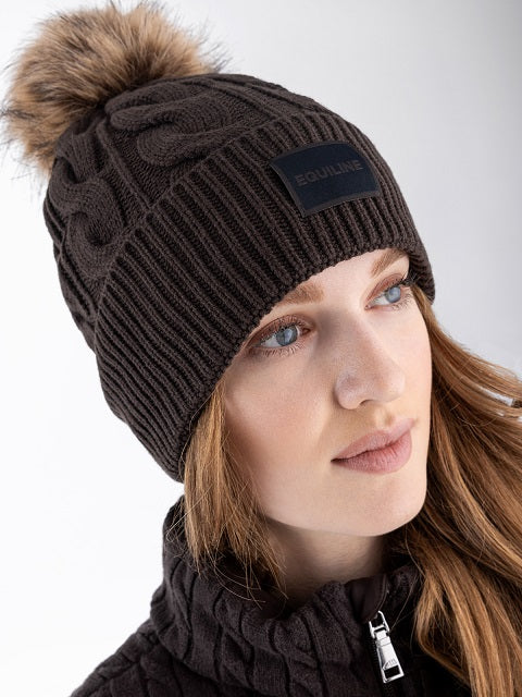 Woman wearing a brown hat and a brown jumper on a white background