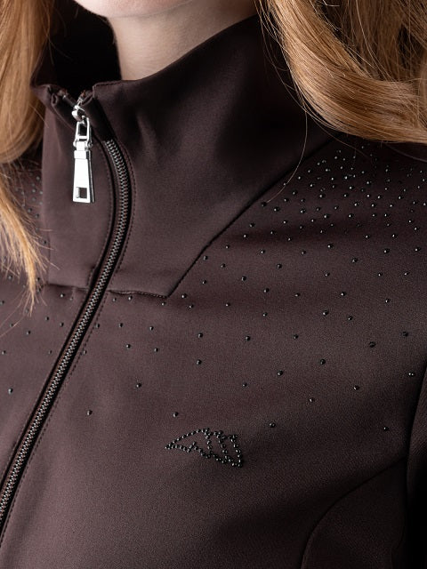 Close-up of a dark brown athletic jacket featuring a high collar, a silver zipper, and small black rhinestone embellishments on the chest.