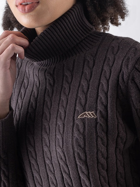 Woman in a brown pullover on a neutral background