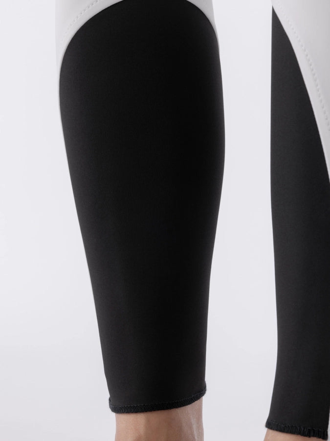 Black sock bottoms of white breeches on a white background