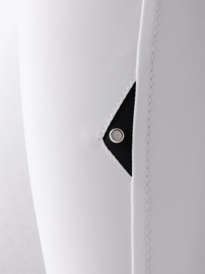 Close-up of an air vent on a white garment with a black background