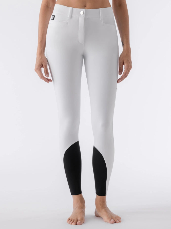 White riding breeches with black sock bottoms worn by a woman on a white background