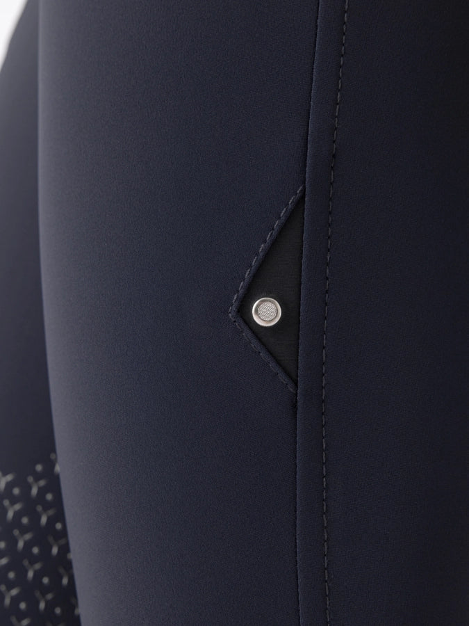Close-up of a navy blue fabric with a button detail