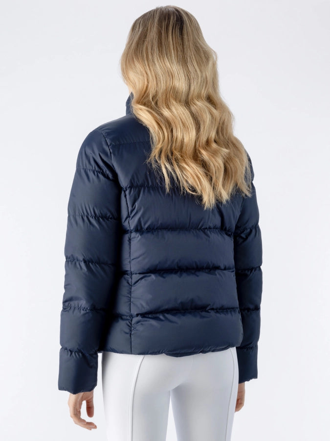 Person wearing a navy puffer jacket on a white background