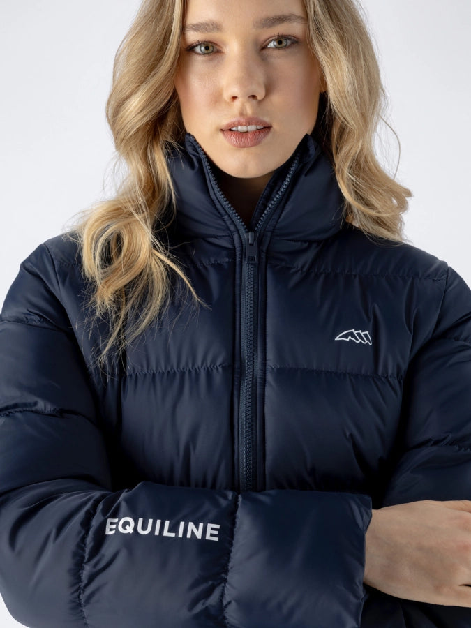 Person wearing a navy puffer jacket with 'Equiline' branding on a white background