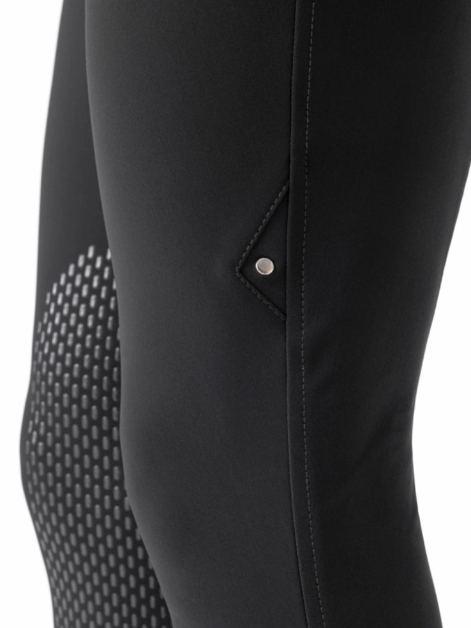 Close-up of black riding pants with a pocket detail on a white background