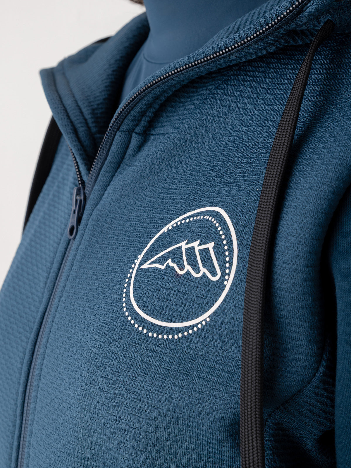 Blue sweatshirt with a white three horse logo on a light gray background