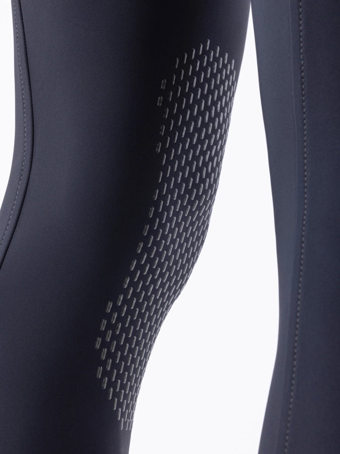 Close-up of dark blue breeches with textured pattern on a white background