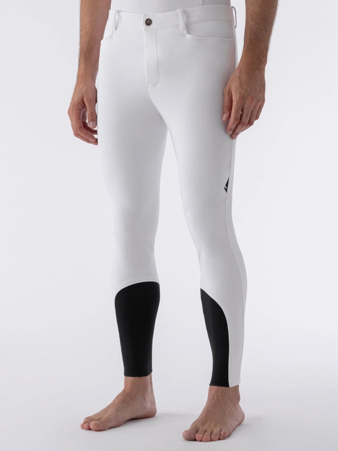White riding pants with black gussets on a white background