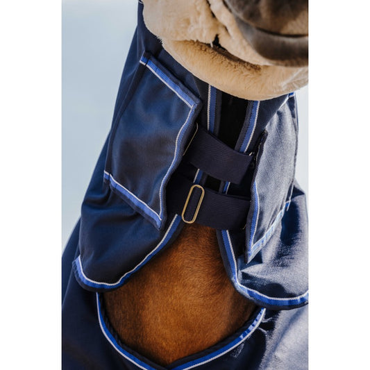 Navy blue horse blanket with a brown horse underneath on a light gray background