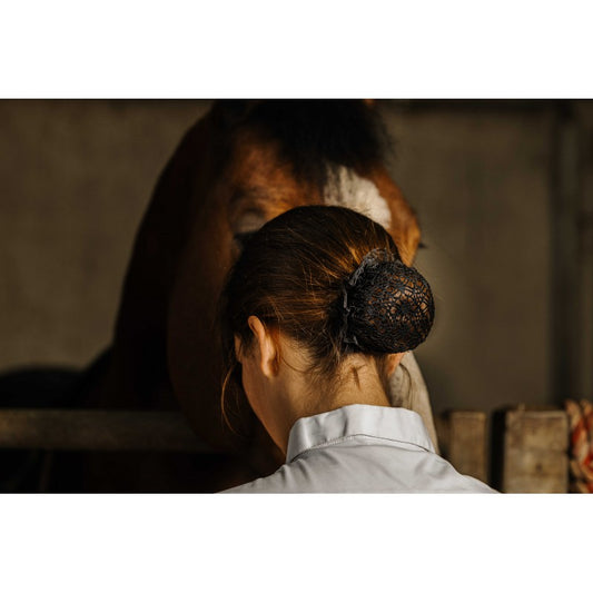 Person with a horse in a stable setting
