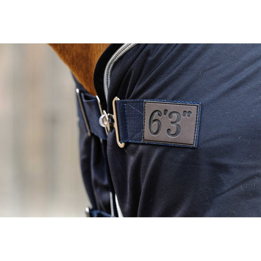 Navy blue rug with a label indicating 6'3" on a blurred background
