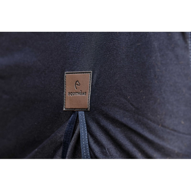 Navy blue fabric with a brown leather label featuring branding.
