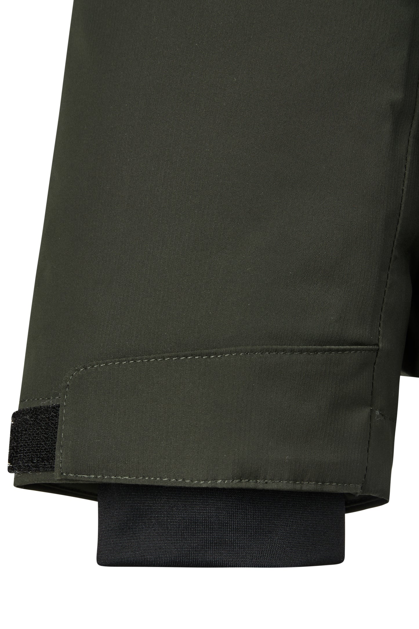 Close-up of a sleeve of a dark green jacket on a white background