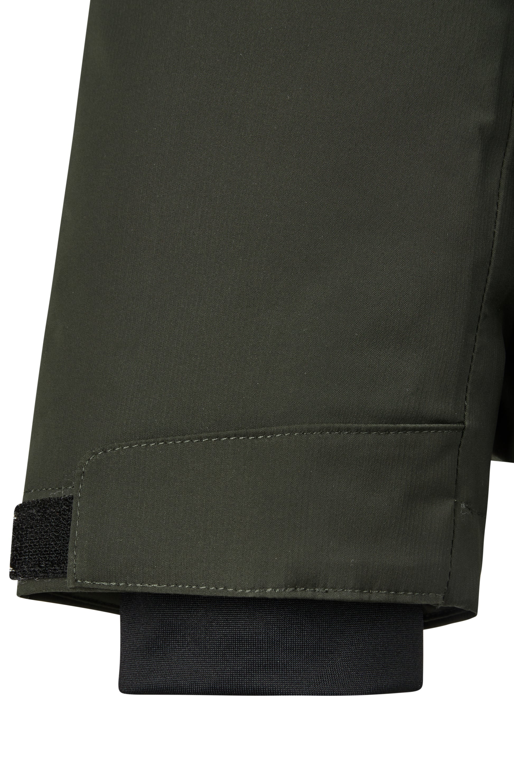 Close-up of a sleeve of a dark green jacket on a white background