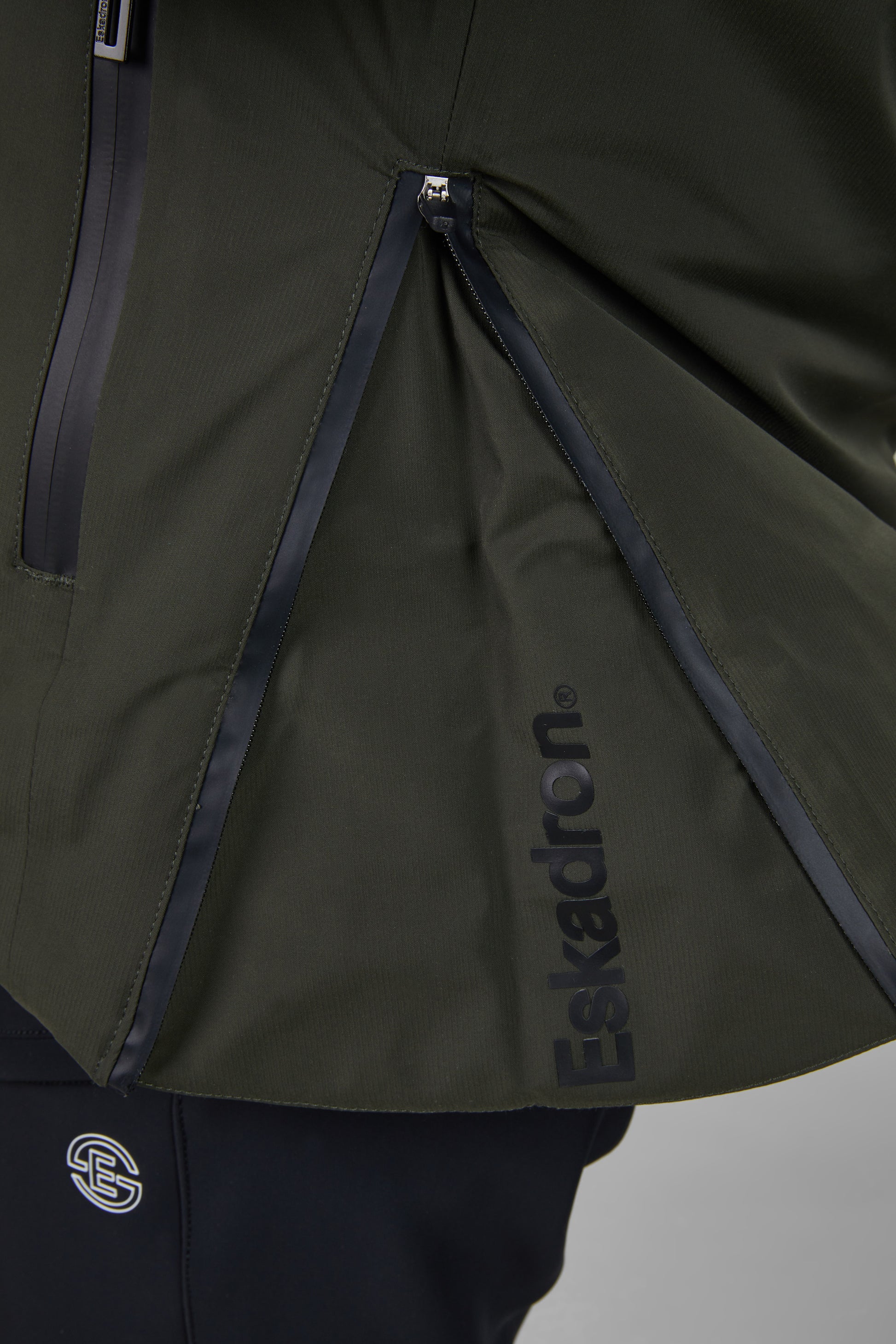Green jacket with 'Eskadron' branding on a gray background