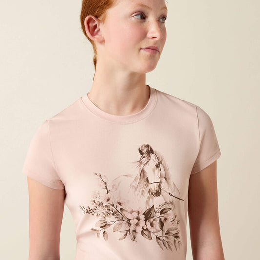 Young girl wearing a pink t-shirt with a horse and floral design on a beige background