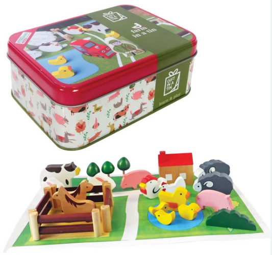 Toy set with farm-themed figures and a tin box featuring farm illustrations.