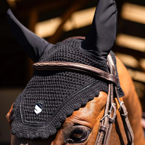 Close up of a black fly veil on a brown horse