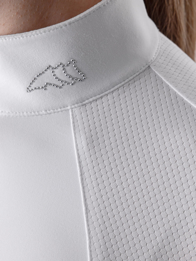 Close-up of a white garment with a small embroidered design on the collar.