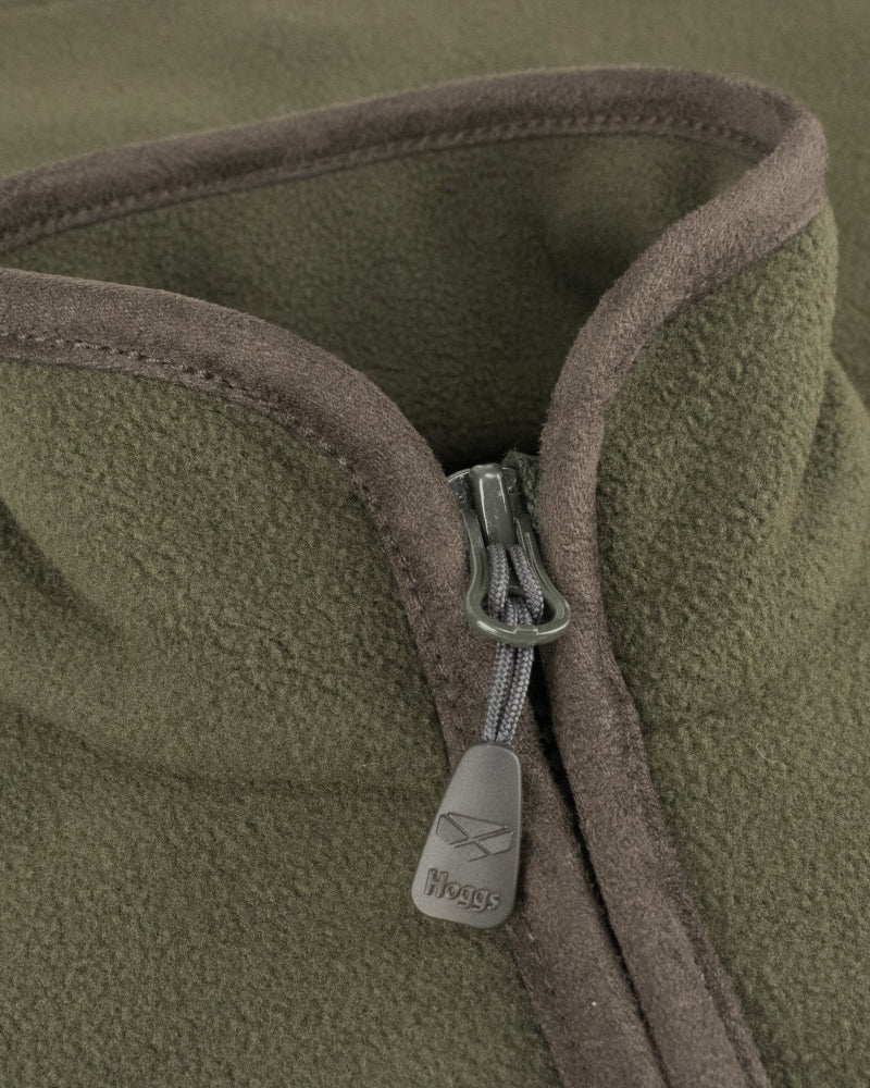 Close up of a zip of a green gilet