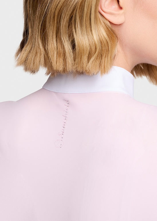 Close-up back view of a model wearing a pale pink high-neck top with a white collar, showing the back neckline stitching against a light gray background.