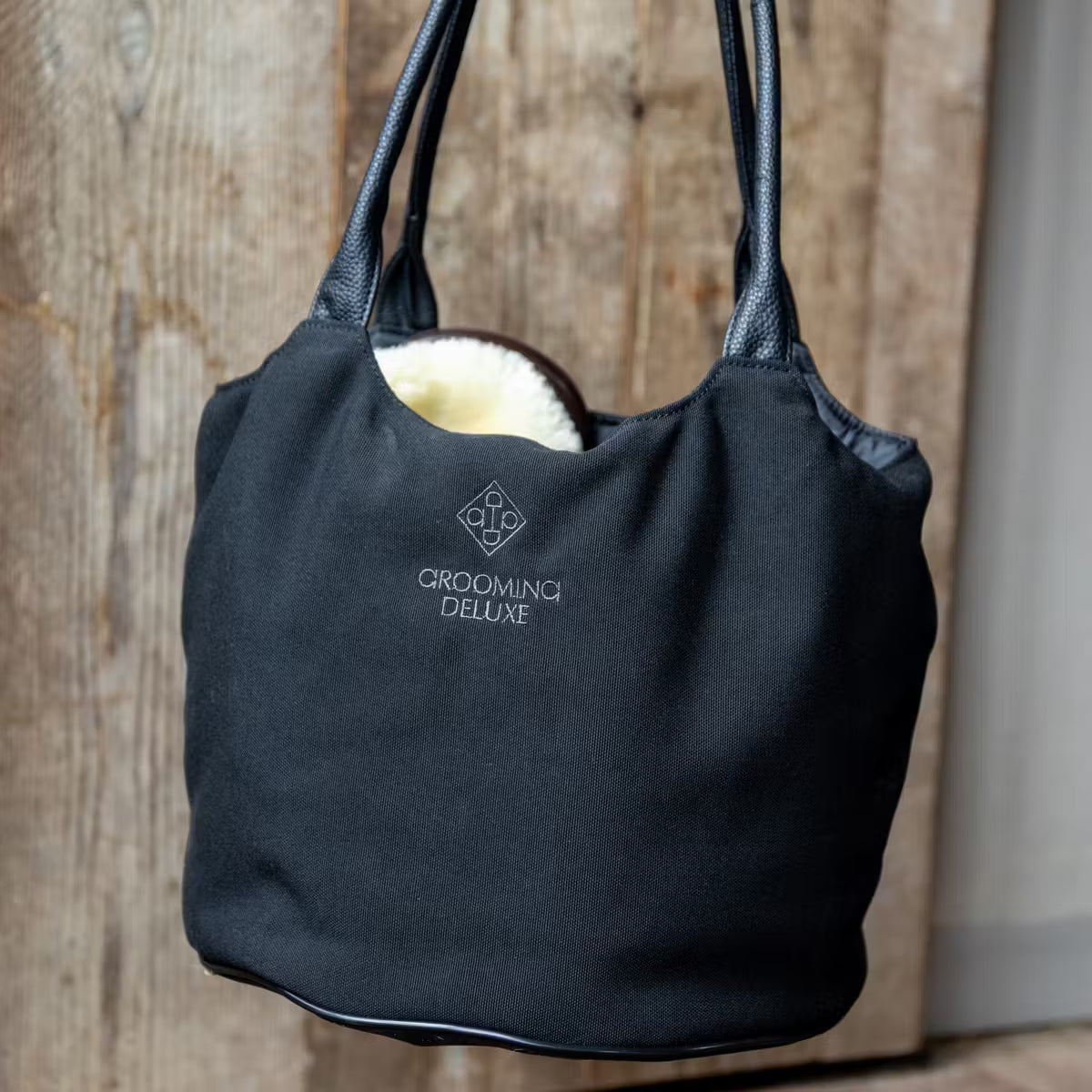 Black grooming bag with Grooming Deluxe branding.