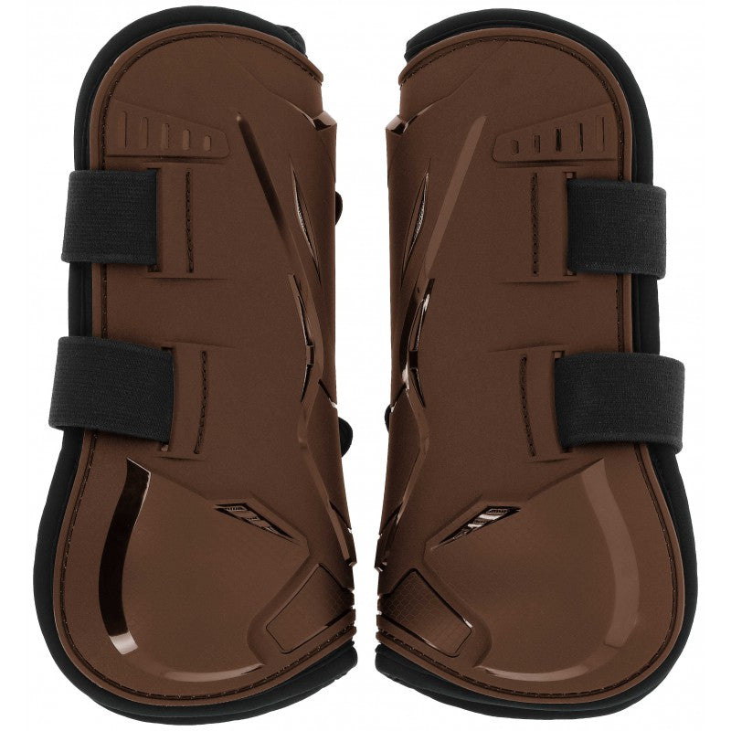 Pair of brown protective horse boots with black straps on a white background