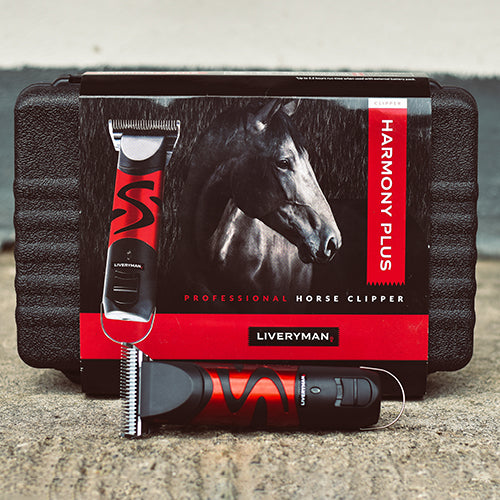 Horse clipper set with black and red design on a gray surface